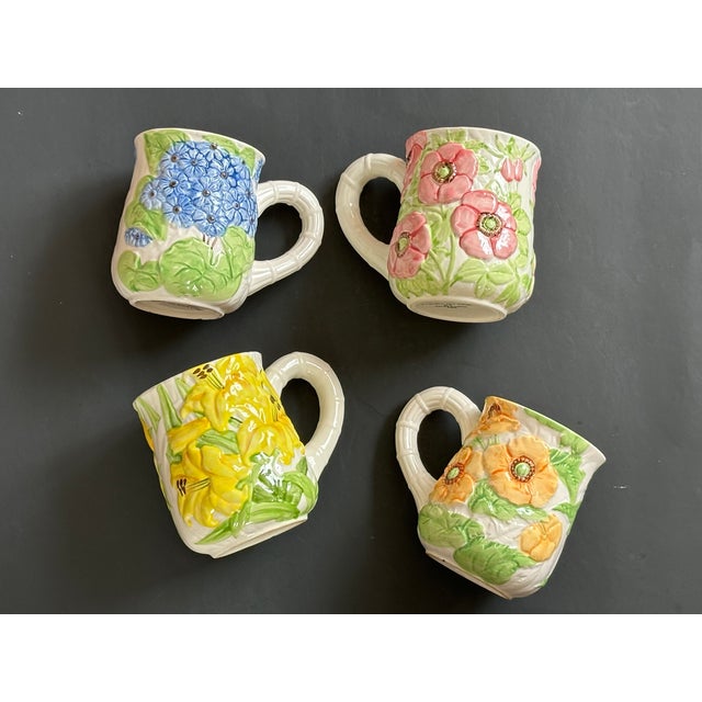 Set your table with these charming floral majolica style pottery mugs and you'll have a touch of spring on your table any...