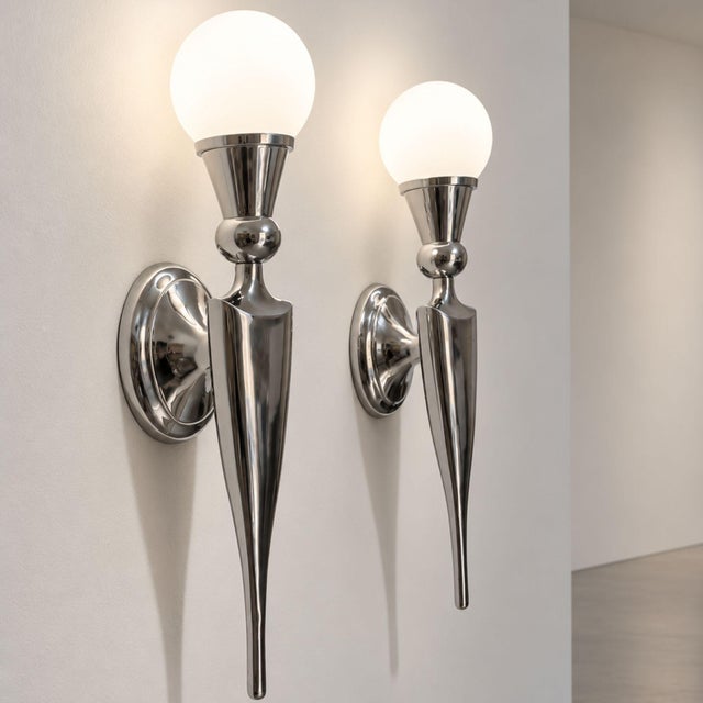 Elegant pair of French wall sconces from the 20th century, designed in a refined Art Deco style and crafted in nickel-...