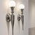 Elegant pair of French wall sconces from the 20th century, designed in a refined Art Deco style and crafted in nickel-...