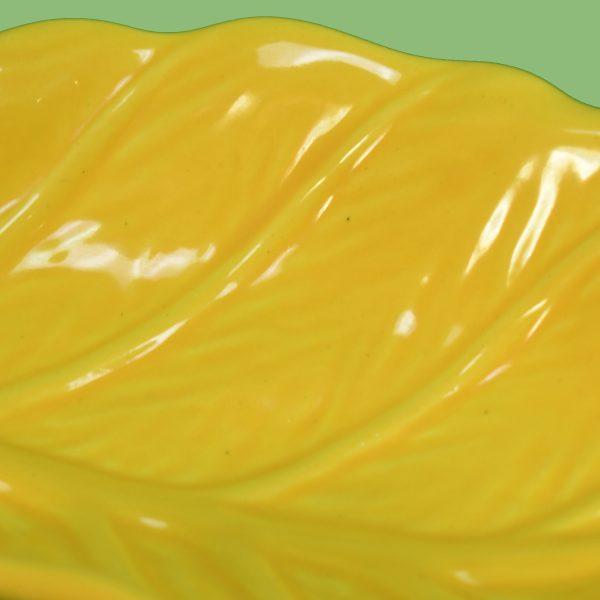 A sweet pair of leaf-shaped ceramic plates in sunny yellow, their molded veins giving each leaf a lifelike feel. The...
