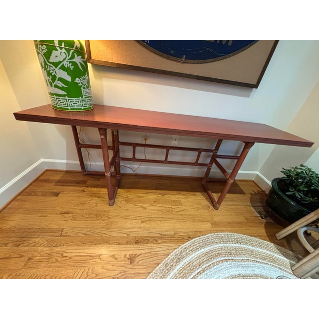 Vintage McGuire table with dark red painted finish. This table combines elegance and versatility, making it an example of...