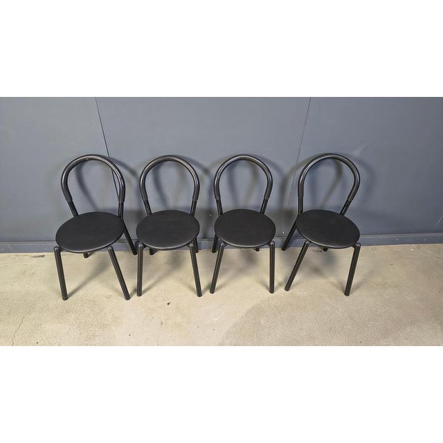 Vintage set of 4 postmodern dining chairs with black metal frames and leatehrette seats. The backrests have black foam...