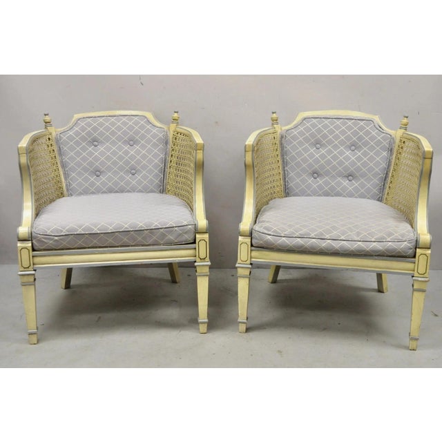 Vintage Hollywood Regency Cream Painted Cane Side Club Lounge Chairs - a Pair. Item features cream painted finish, blue...