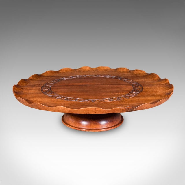 This is an antique canapé party turntable. An Anglo-Indian, carved mahogany rotary serving tray or Lazy Susan, dating to...