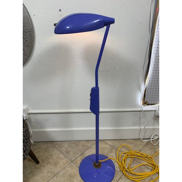 Vintage industrial floor lamp featuring a striking cobalt blue metal finish, large oval-shaped shade, and heavy-duty steel...