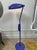 Vintage industrial floor lamp featuring a striking cobalt blue metal finish, large oval-shaped shade, and heavy-duty steel...