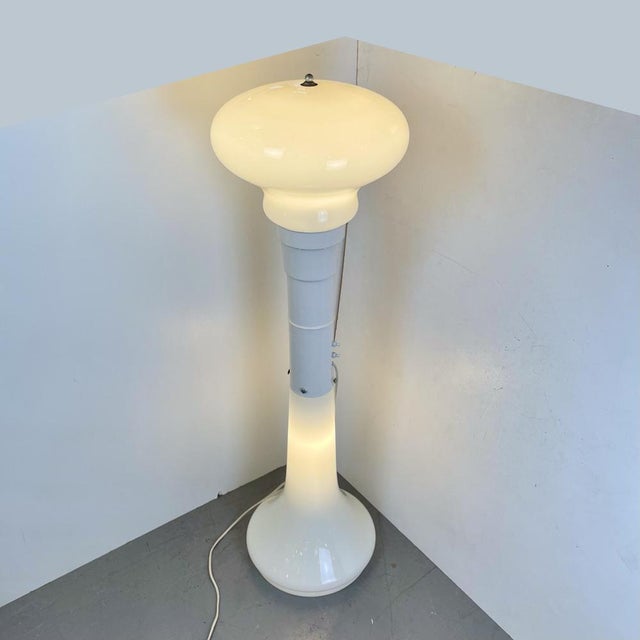 Astounding double-source floor lamp made of white Murano glass with a white lacquered central fixture. Both the bottom and...