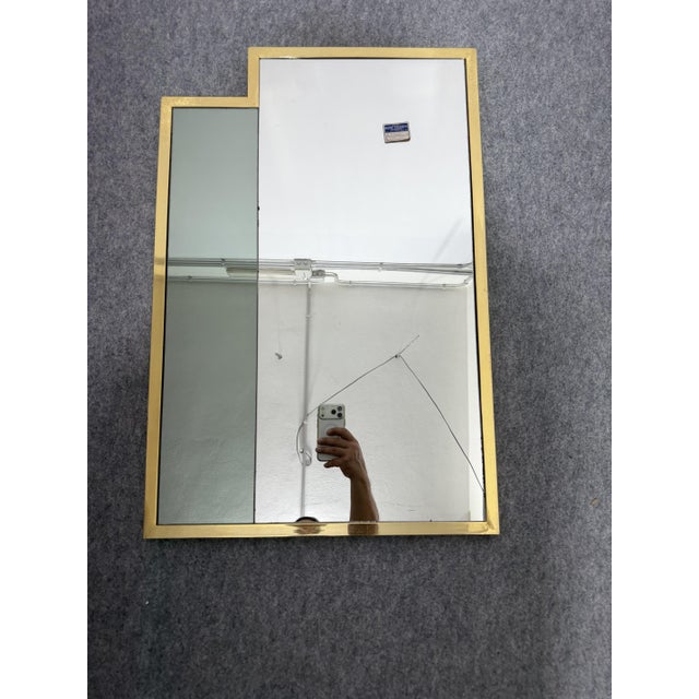 Brass wall mirror, made in Italy, 1970 Contrasting colored glass insert on the left. It still has the original dealer's...