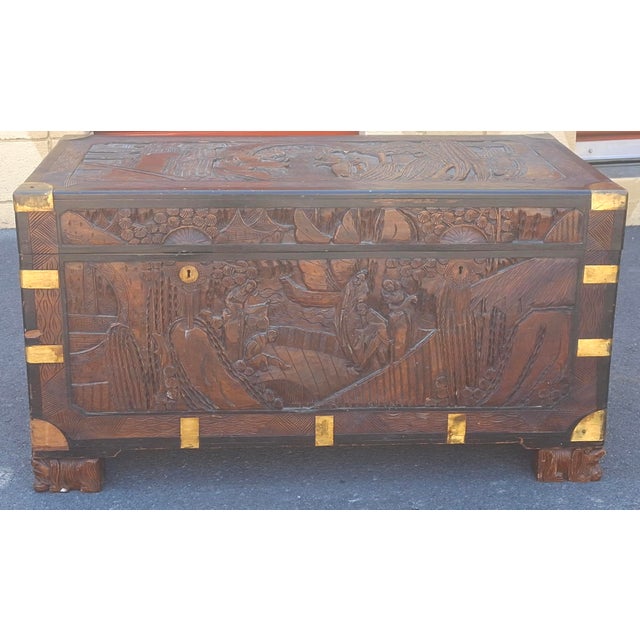 20th Century Chinese Carved Camphorwood Coffer with brass accents Measures 40" in width, 20" in depth and 30" in height.