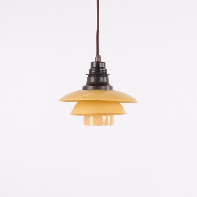 Ph 2/2 pendant designed by poul henningsen and manufactured by louis poulsen in denmark during the 1930s. The lamp...