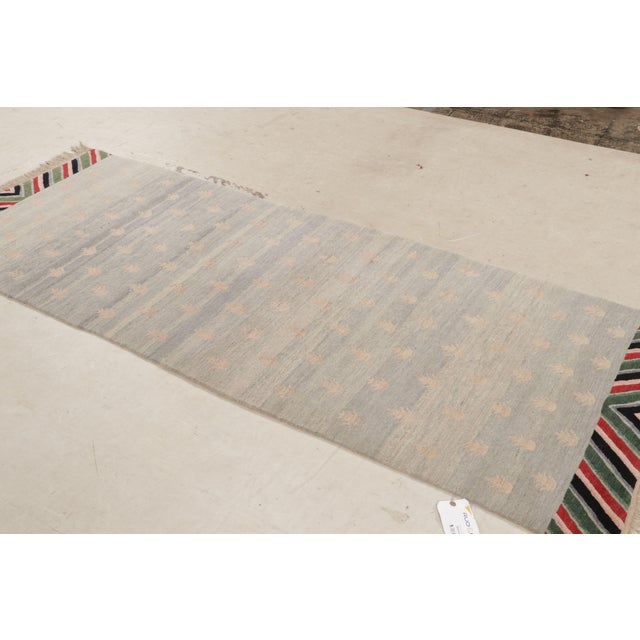 Hand knotted with durable wool originating from Nepal, this contemporary wool rug features a unique geometric Youngste...