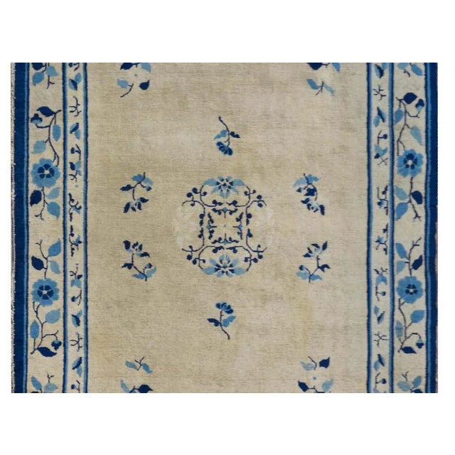 An outstanding late 19th century Chinese Peking rug woven in natural un-dyed wool with a large round chrystantmum...