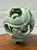 This stunning piece is a true work of art, hand-carved from natural green jade into a mesmerizing puzzle sphere. At first...