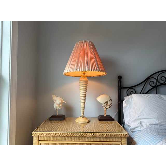 Unique Auger shell shaped turned wood table lamp with brass accents. The wood is in an original high gloss finish. Paired...