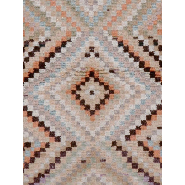 This mid-20th-century Turkish Anatolian throw rug presents a geometric composition built from small checkerboard blocks...