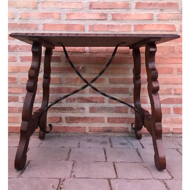 Side table of chestnut with carved lyre base and ebonized details in the legs, Spanish, 18th century.DimensionsHeight: 20...