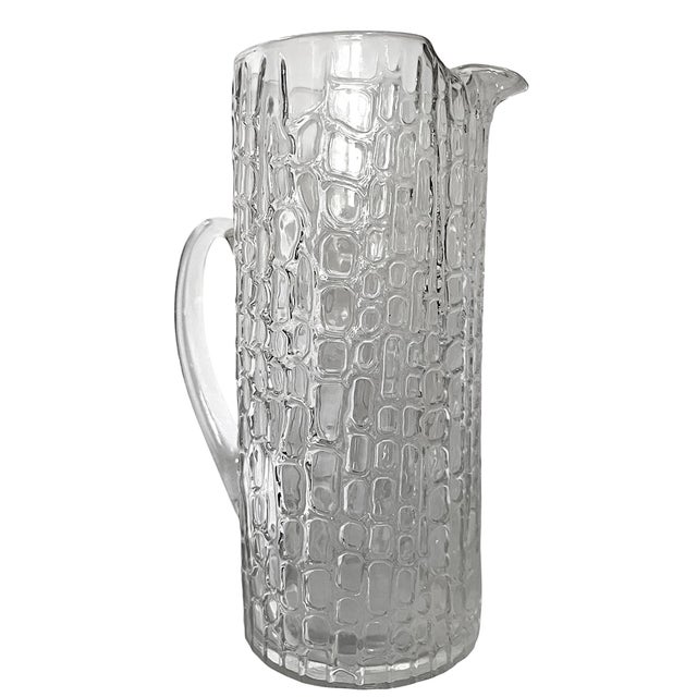 Striking vintage clear art glass pitcher featuring an allover embossed crocodile or reptile-inspired texture that...