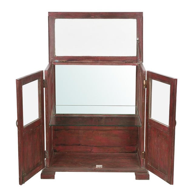Wooden display case with red patina. This piece is designed in the style of the selected designer and/or manufacturer