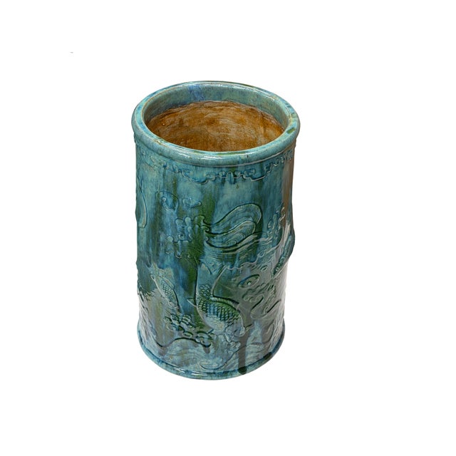 This cylindrical ceramic umbrella stand or floor dry flower container is finished in a vibrant, multi-tonal turquoise and...