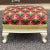 A one of a kind funky antique ottoman or footstool with velvet upholstery and welting around lower sides topped off with a...