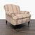 This lounge chair by Ralph Lauren features a classic striped floral upholstery in soft pink and cream tones. It has rolled...