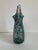 A hand-blown art glass vase. I love how you can visualize it hanging from a rod fresh from a glass-furnace. Colors include...