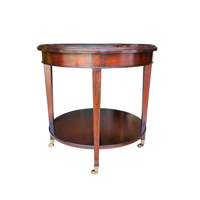 Neoclassical Vintage Mahogany Two-Tier Side Table | Bookmatched Starburst Top | Fluted Legs | Brass Caster Feet For Sale - Image 3 of 11