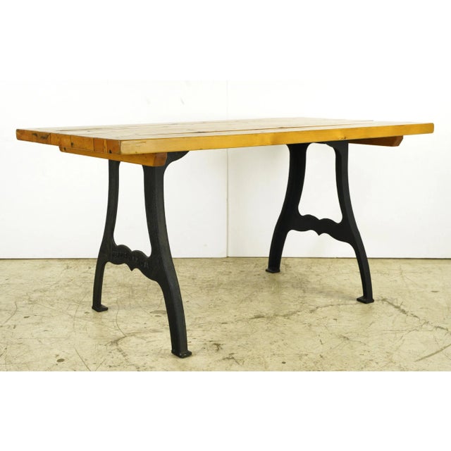 This piece is made of a cedar tabletop paired with cast iron New York style legs. There is minor bubbling in the wood on...