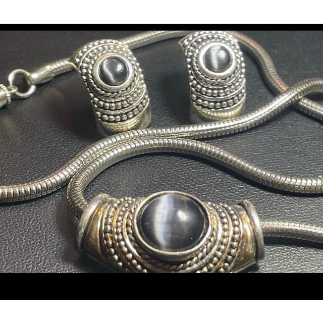 Outstanding set by vintage designer Roman. The sophisticated cats eye cabochons in mauve color. The item is on 19” thick...