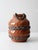 Vintage handmade studio pottery vase with a sculptural rounded form, applied chain detailing, and looped rim handles....