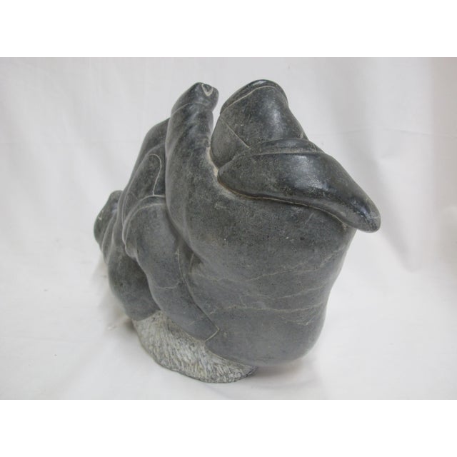 Pitseolak Koperqualuk in Salluit, Nunavik, Quebec, Canada, inuit stone carving of a man and a seal. Etched signature,...
