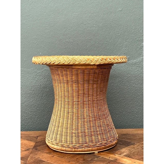 This vintage braided rattan accent table is a beautiful expression of mid-century craftsmanship, blending organic...
