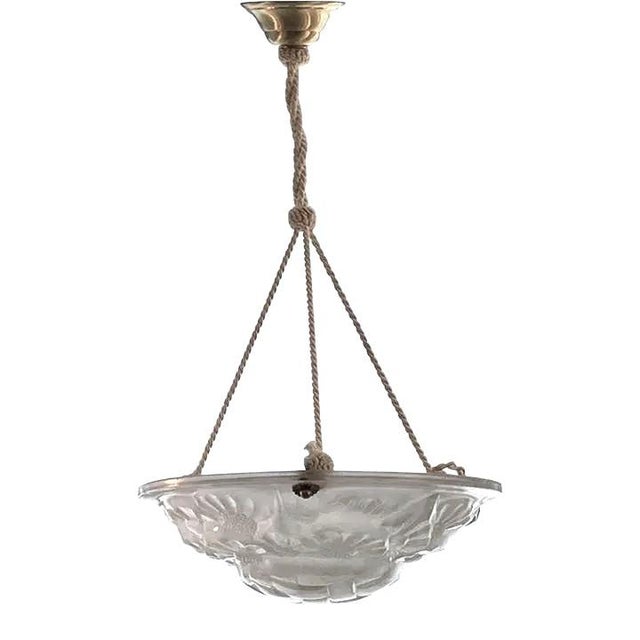 This stylish and chic Art Deco chandelier was designed by and it dates to the 1920s-1930s. \\ The piece is marked with the...