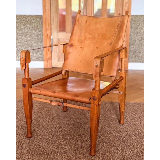 One wonderful natural dark oak wood safari chair, designed by Wilhelm Kienzle / Kare Klint, in 1928 for Wohnbedarf and...