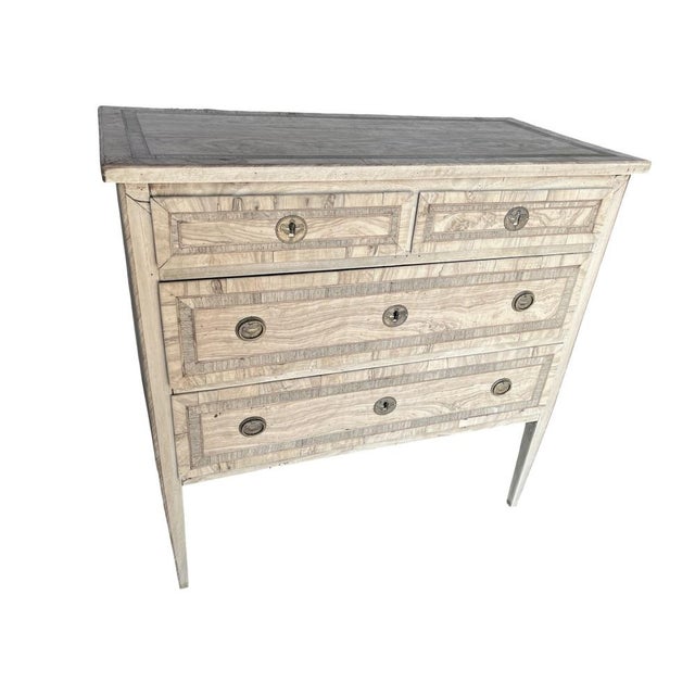 Neoclassical commode hand-made in Italy in the early 1800s using walnut and decorated with walnut veneer. The commode...