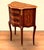 Elegant and compact, this French Louis XV-style side table features a beautifully curved silhouette, rich wood finish, and...