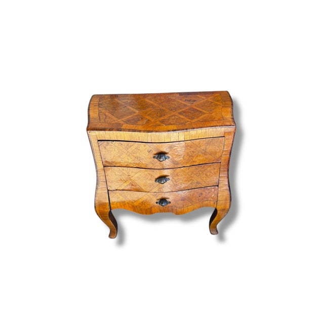This elegant small commode showcases classic European craftsmanship with a beautifully curved silhouette and intricate...