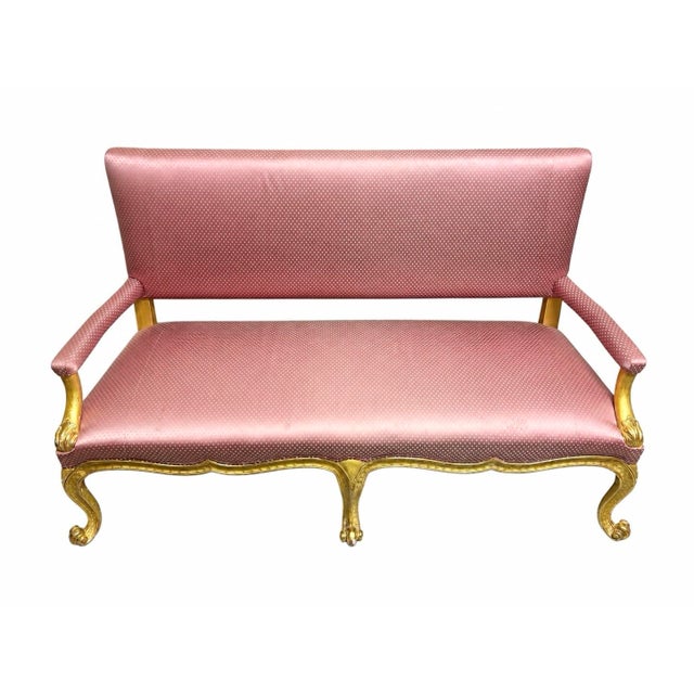 This French Louis XV style settee features a distinctive pink polka-dot upholstery and a gilded wooden frame Measuring...