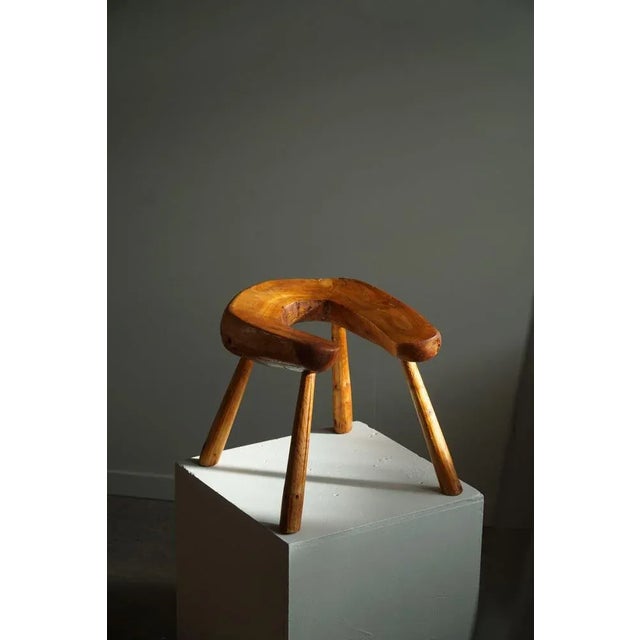 Decorative Scandinavian stool with organic shape in solid pine. Hand carved by a Swedish cabinetmaker in 1950s. This wabi...