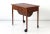 This teak sewing box table on castors was produced in Denmark in the 1960s.