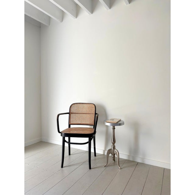 A striking French side table in cast aluminium with a distinctive tripod base featuring arched and scrolled feet. H 61.5cm...