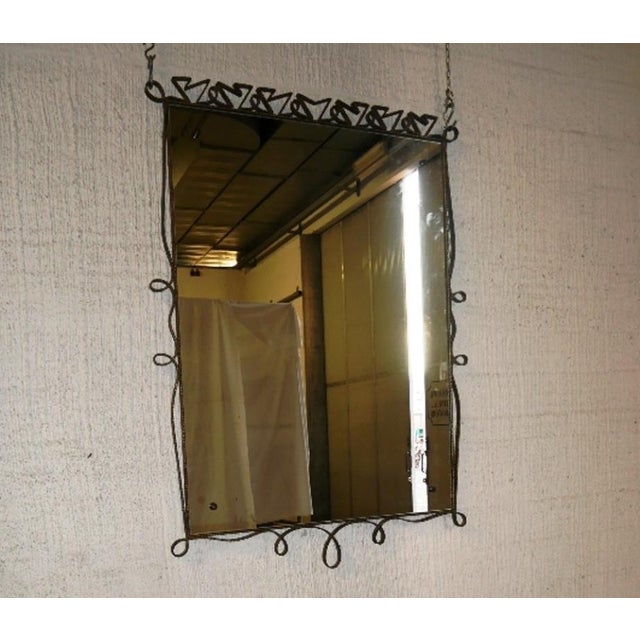 Mirror with hammered gold metal frame, curls and decorations, 1950s/60s, Pier Luigi Colli Height 142 x 104 cm At the back,...