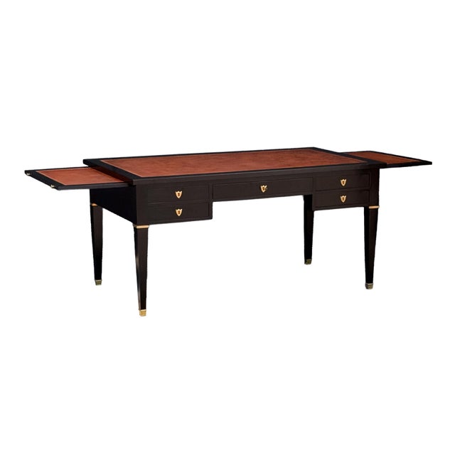 An elegant and large scale French writing table or executive bureau plat desk of ebonized mahogany with gilt accents in...