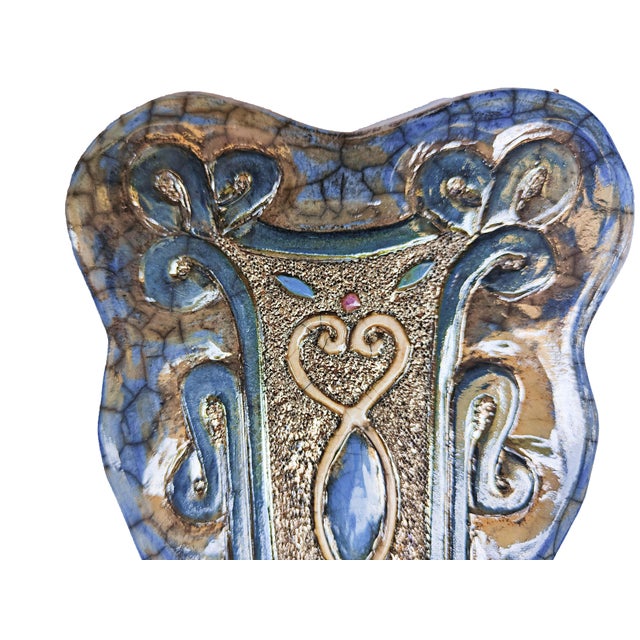 "The Heart Enclosed in a Weave" is a unique Raku ceramic work, entirely hand-molded and decorated by artist Stefania...