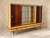 Half furniture, half stage set. Deep, glossy reddish brown doors slide to either side of a glass center with two glass...