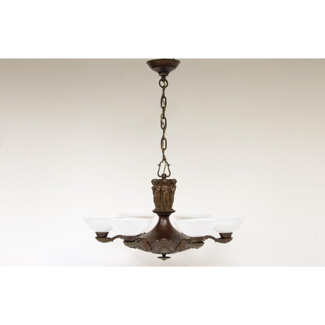 An impressive chandelier made of patinated bronze and brass, likely manufactured around 1920 in germany or austria. the...