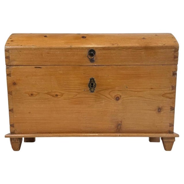 A handsome 19th-century English dome-top storage chest, finely constructed from pine and distinguished by its beautifully...