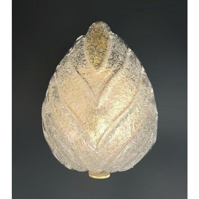 Italian wall light with a Murano glass leaf hand blown in Graniglia technique to produce granular textured effect, mounted...