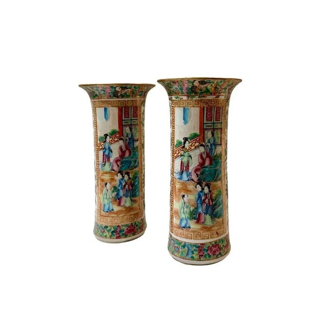 A fabulous pair of 19th century rose medallion trumpet vases with courting scenes.