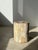 Side table, pedestal table or occasional furniture in multicolored petrified wood, predominantly light. Petrified wood is...